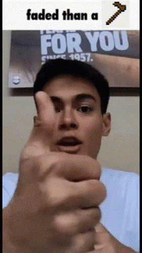 A Man Is Giving A Thumbs Up In Front Of A Poster That Says " For You " GIF