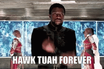 A Man Is Giving A Thumbs Up In Front Of A Screen That Says Hawk Tuan Forever GIF