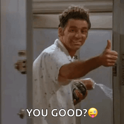 A Man Is Giving A Thumbs Up While Holding A Bottle Of Water . GIF