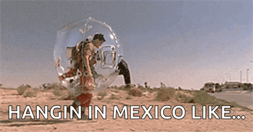 A Man Is Hanging In A Bubble In The Desert With The Words Hangin In Mexico Like Written Below Him . GIF