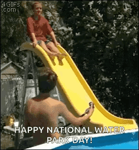 A Man Is Helping A Child On A Water Slide . GIF