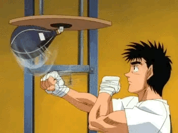 A Man Is Hitting A Punching Bag In A Boxing Ring . GIF