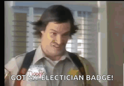 A Man Is Holding A Badge And Saying `` Got My Electrician Badge '' GIF