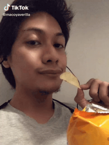 A Man Is Holding A Bag Of Chips In Front Of His Face And Says Tiktok GIF