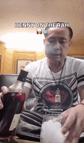 A Man Is Holding A Bottle Of Alcohol And A Glass Of Ice And The Caption Says Henny On The Rah GIF
