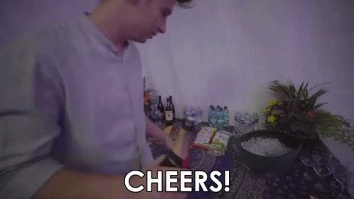 A Man Is Holding A Bottle Of Champagne And Saying `` Cheers '' . GIF