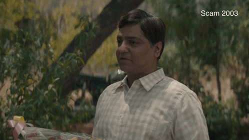 A Man Is Holding A Bouquet Of Flowers And The Words Congratulations Are On The Screen GIF