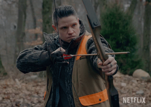 A Man Is Holding A Bow And Arrow With A Netflix Logo In The Background GIF