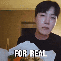 A Man Is Holding A Box Of Food With The Words For Real Written On It GIF