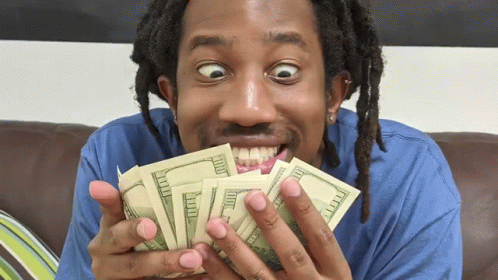 A Man Is Holding A Bunch Of Money In His Hands GIF