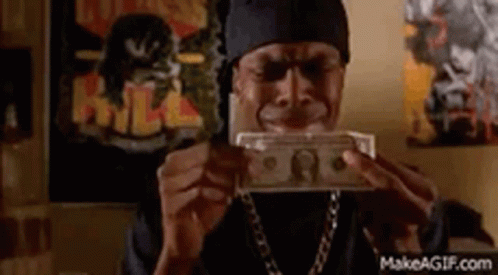 A Man Is Holding A Bunch Of Money In His Hands . GIF