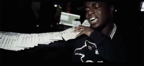 A Man Is Holding A Bunch Of Papers In His Hand GIF