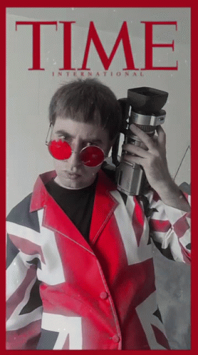 A Man Is Holding A Camera On A Time Magazine Cover GIF