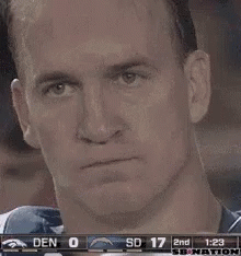 a man is holding a can of soda in front of his face during a game .