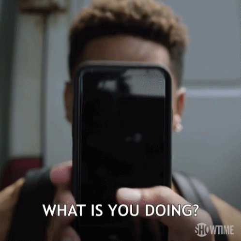 A Man Is Holding A Cell Phone In Front Of His Face And Asking What Is You Doing .. GIF