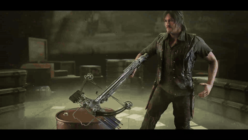 A Man Is Holding A Crossbow In His Hand GIF