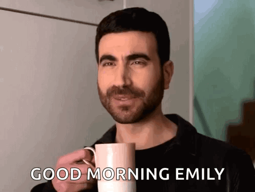 A Man Is Holding A Cup Of Coffee And Saying Good Morning Emily . GIF