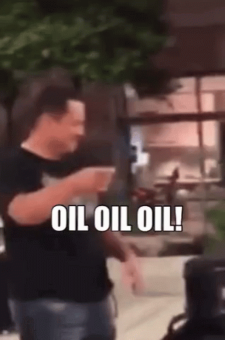 A Man Is Holding A Cup Of Coffee And Saying Oil Oil Oil GIF