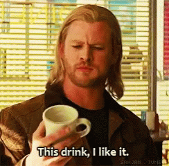 A Man Is Holding A Cup Of Coffee And Says This Drink I Like It GIF