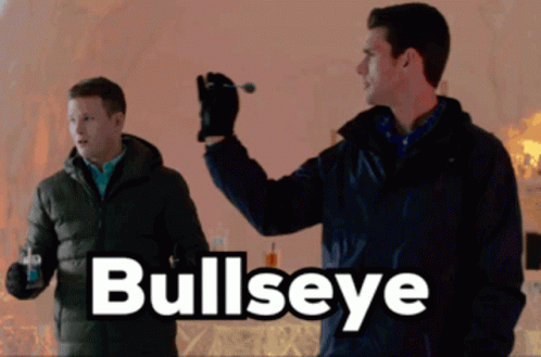 A Man Is Holding A Dart In His Hand And The Word Bullseye Is On The Bottom GIF