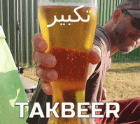 A Man Is Holding A Glass Of Beer With The Word Takbeer On The Bottom GIF