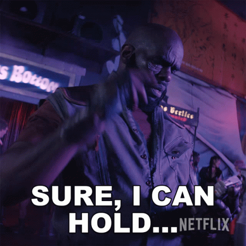 A Man Is Holding A Gun And Says " Sure I Can Hold " GIF