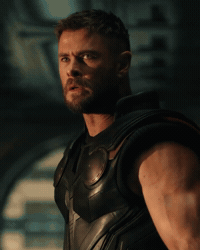 A Man Is Holding A Hammer In His Right Hand GIF