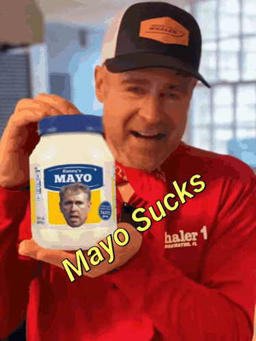 A Man Is Holding A Jar Of Mayo With A Picture Of George Bush On It GIF