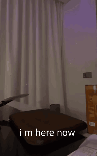 A Man Is Holding A Knife Over A Cutting Board And Says " Im Here Now " In The Corner GIF