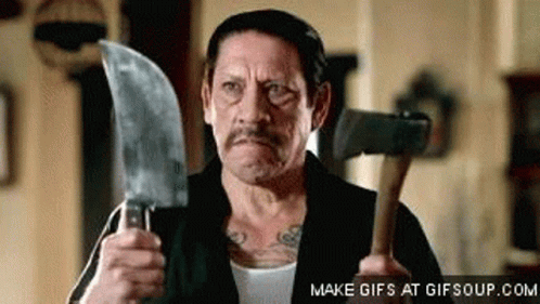 A Man Is Holding A Large Knife And A Hammer . GIF