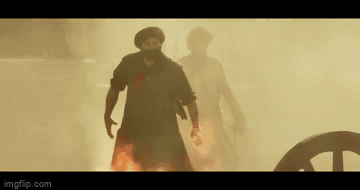 A Man Is Holding A Large Shield Over His Head In A Scene From A Movie GIF
