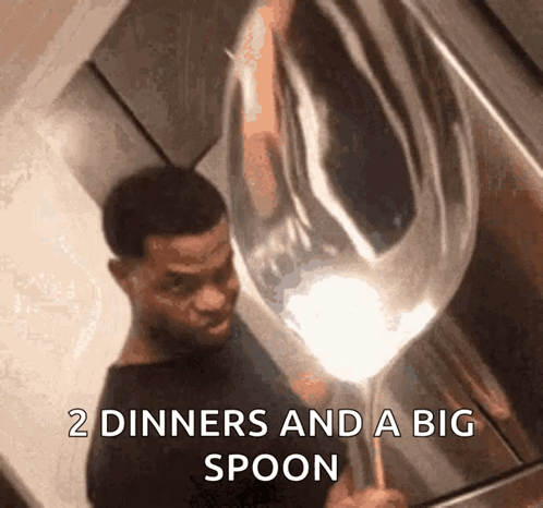 A Man Is Holding A Large Spoon That Says " 2 Diners And A Big Spoon " GIF