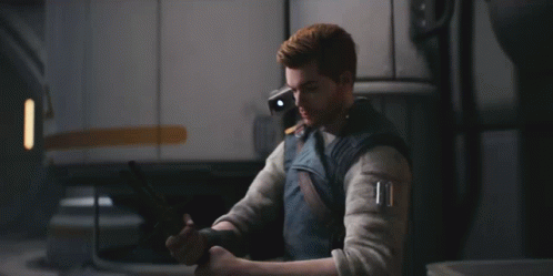 A Man Is Holding A Light Saber In A Room GIF
