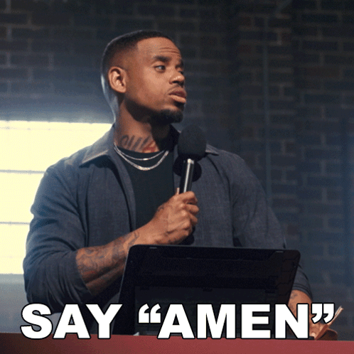 A Man Is Holding A Microphone And Says Amen GIF