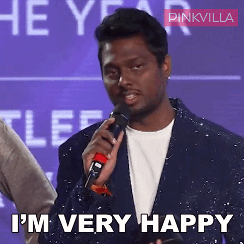 A Man Is Holding A Microphone And Says I 'M Very Happy GIF