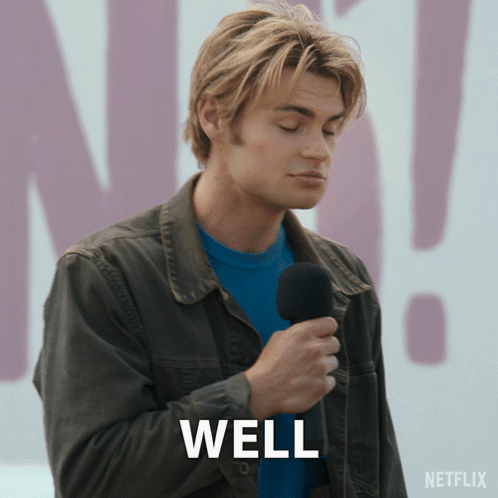 A Man Is Holding A Microphone And The Word Well Is On The Screen GIF