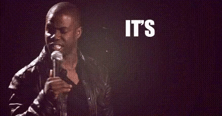 A Man Is Holding A Microphone In Front Of A Sign That Says `` It 'S About To Go '' GIF
