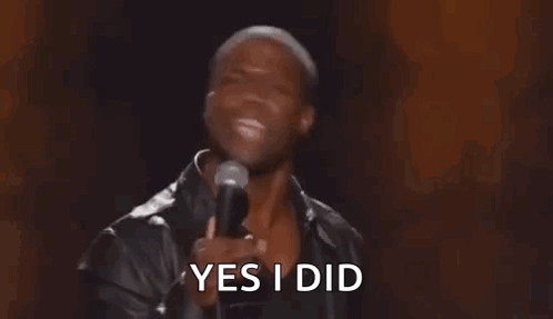 A Man Is Holding A Microphone In His Hand And Saying Yes I Did . GIF