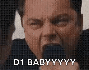 A Man Is Holding A Microphone In His Mouth And Saying `` D1 Baby Yyy '' . GIF