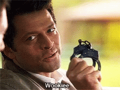 A Man Is Holding A Pair Of Handcuffs And Saying Wookiee GIF
