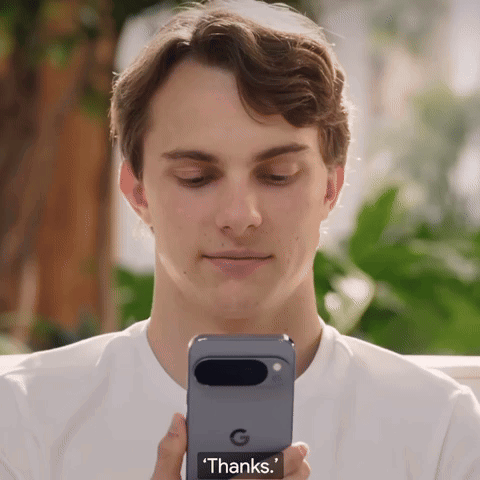 A Man Is Holding A Phone That Says ' Thanks ' On The Screen GIF