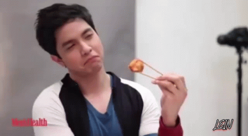 A Man Is Holding A Piece Of Food With Chopsticks And Lean Is Written On The Bottom GIF