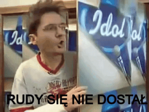 A Man Is Holding A Piece Of Paper That Says Idol On It GIF