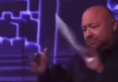 A Man Is Holding A Piece Of Paper That Says Liberal On It GIF