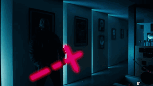A Man Is Holding A Pink X Shaped Object GIF