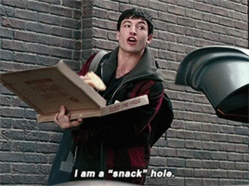 A Man Is Holding A Pizza Box And Saying I Am A " Snack " Hole GIF