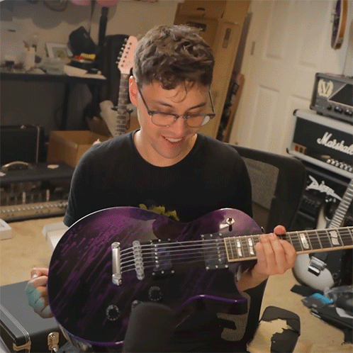 Man Holding Purple Guitar In Front Of Marshall Amp GIF