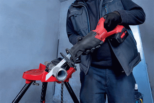 A Man Is Holding A Red And Black Tool That Says ' Rothenberger ' On It GIF