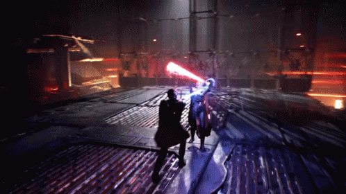 A Man Is Holding A Red Light Saber While Another Man Is Holding A Blue Light Saber GIF