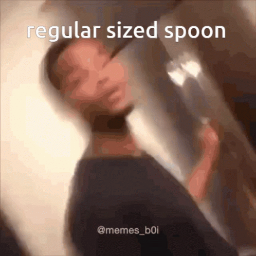 A Man Is Holding A Regular Sized Spoon GIF